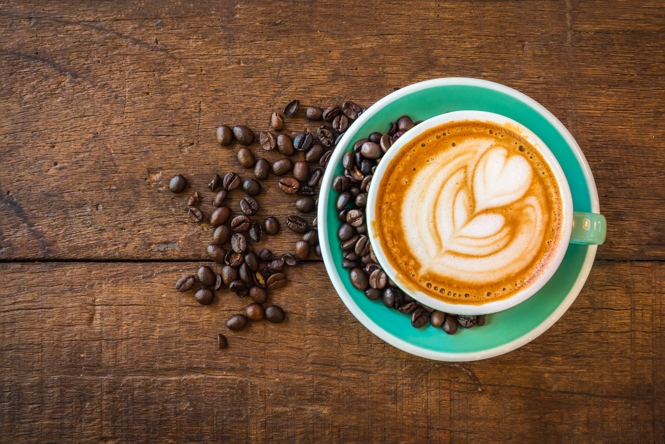 Latte hot coffee and roasted coffee beans.